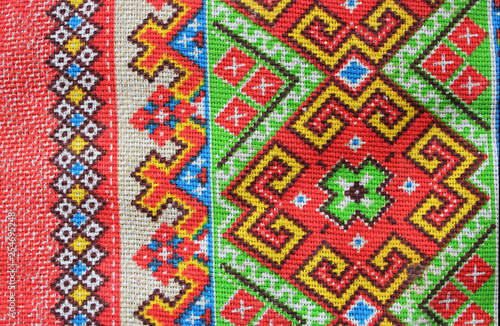 folk textile ornament of bright colors  consisting of patterns of geometric shapes and lines