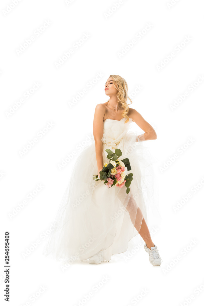 beautiful young woman posing in wedding dress and sneakers isolated on white beautiful young woman posing in wedding dress and sneakers isolated on white