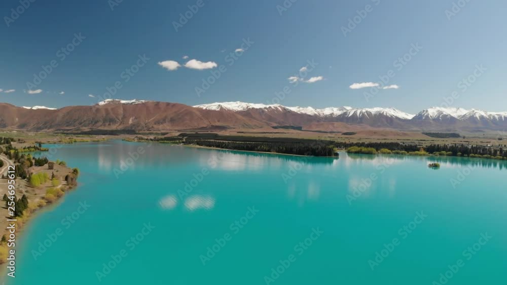 Lake Ruataniwha, New Zealand, South Island, trees and mountains, azure water reflections Lake Ruataniwha, New Zealand, South Island, trees and mountains, azure water reflections