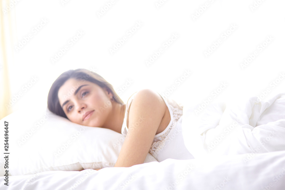 beautiful young woman basking in bed in the morning. Beautiful Model face looks sexy in camera beautiful young woman basking in bed in the morning. Beautiful Model face looks sexy in camera
