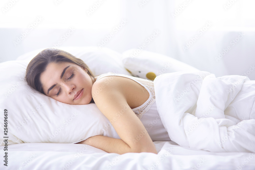beautiful young woman basking in bed in the morning. Beautiful Model face looks sexy in camera beautiful young woman basking in bed in the morning. Beautiful Model face looks sexy in camera