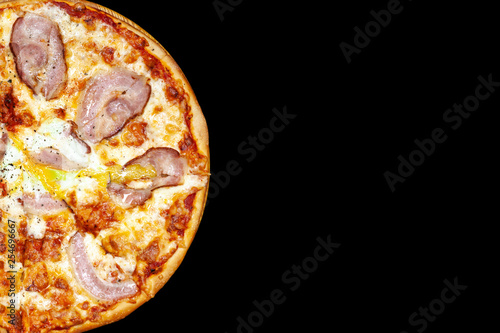 Fresh pizza with meat beaf chicken pork, tomatoes, vegetables, ushrooms on dark black background closeup photo