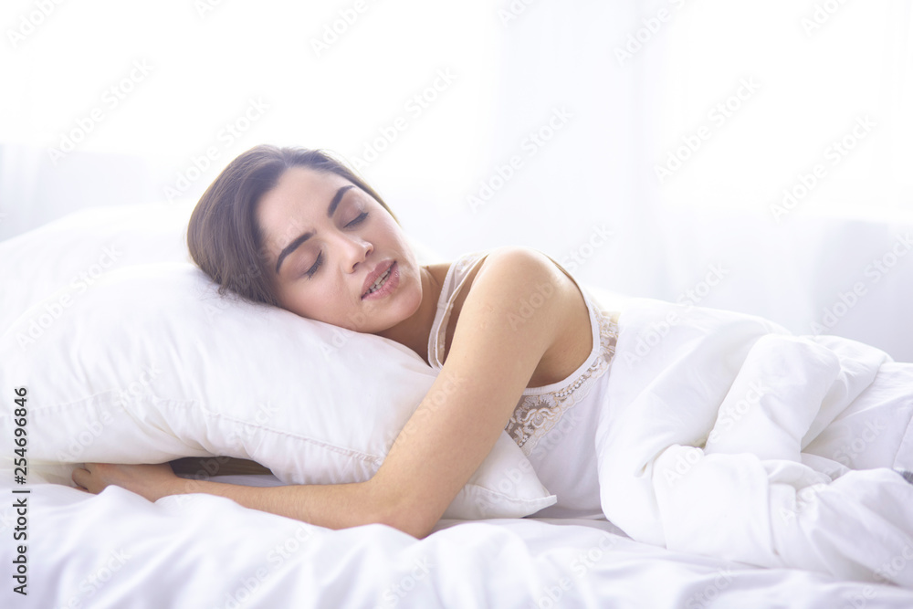 beautiful young woman basking in bed in the morning. Beautiful Model face looks sexy in camera beautiful young woman basking in bed in the morning. Beautiful Model face looks sexy in camera