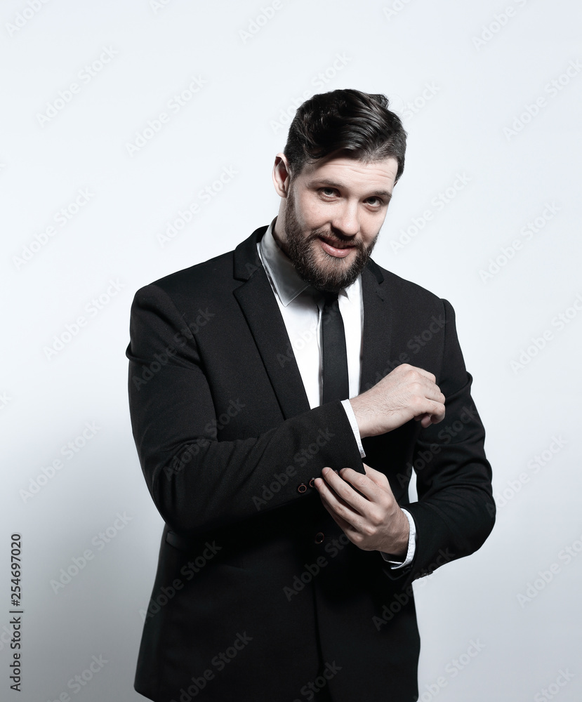 serious businessman adjusting his cuff link on the sleeve of the shirt serious businessman adjusting his cuff link on the sleeve of the shirt
