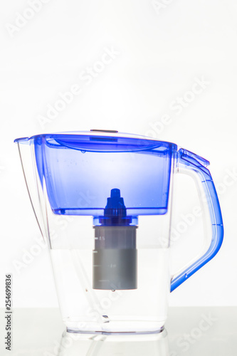 Filter pitcher with water on white background