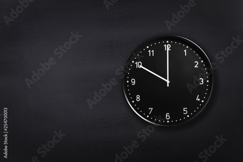 Wallpaper Mural Black wall clock showing ten o'clock on black chalkboard background. Office clock showing 10am or 10pm on black texture Torontodigital.ca