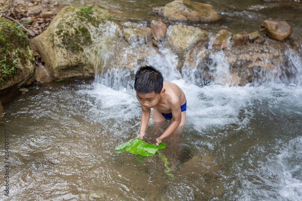 Fototapeta premium Children play happily in the stream.