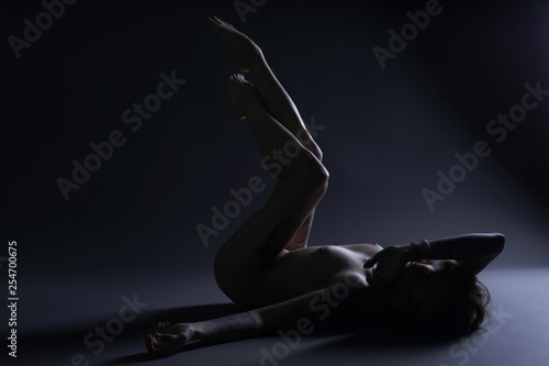 Naked girl is  lying on the floor in the studio  © dima