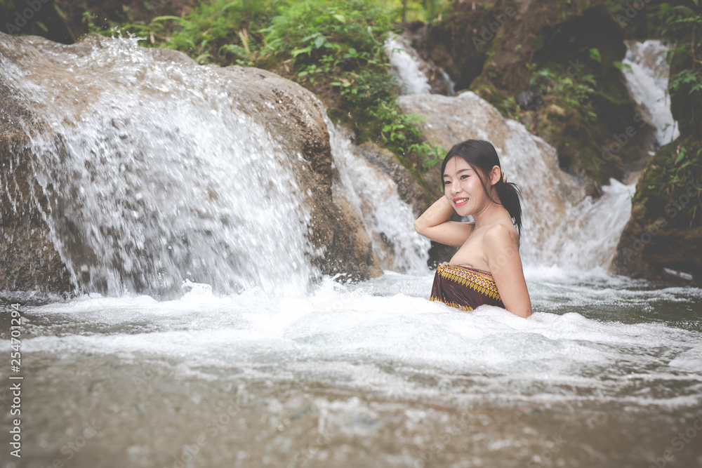 Happy bathing women at the natural waterfall. Happy bathing women at the natural waterfall.