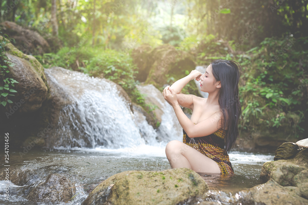 Happy bathing women at the natural waterfall. Happy bathing women at the natural waterfall.