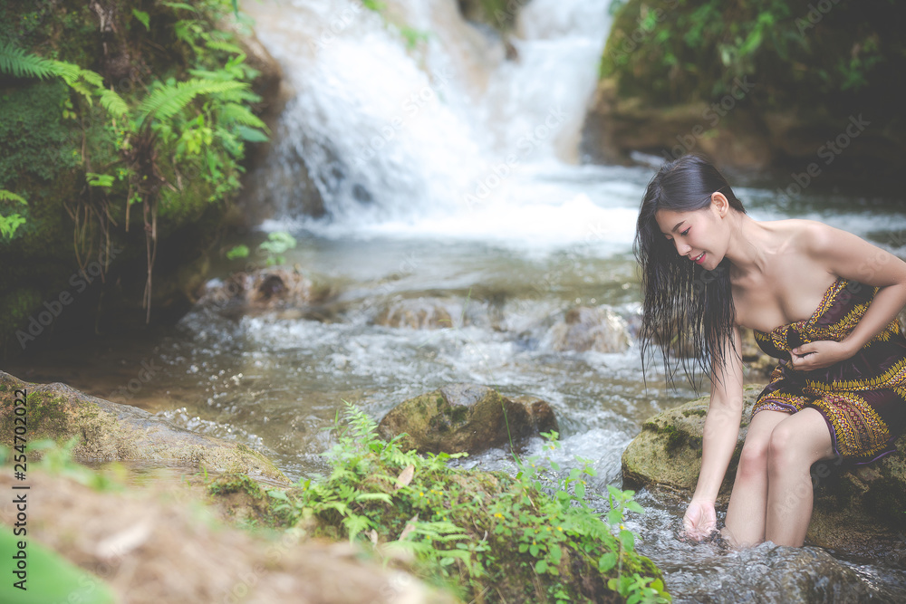 Fototapeta premium Happy bathing women at the natural waterfall.
