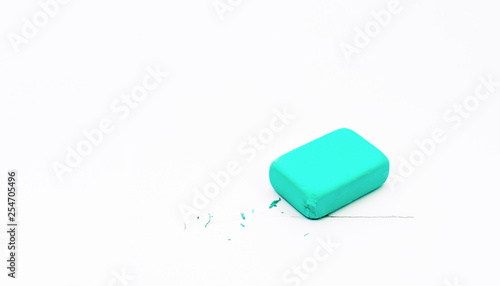 Blue eraser on a white background. Line drawn in pencil. Eraser erases the line. Turquoise. Education. Back to school. Stationery.