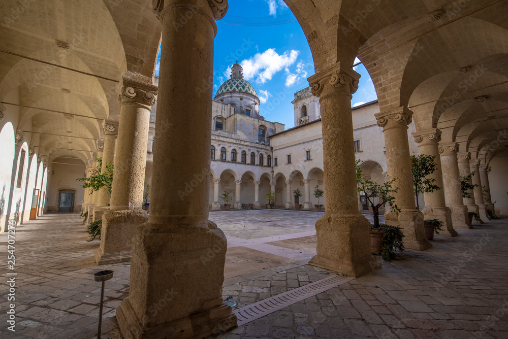LECCE, Puglia ,Italy - Inside courtyard of university of Salento - UniSalento (Universita del Salento) and view to cupola of the church chiesa Maria ss.del Carmine. Apulia region