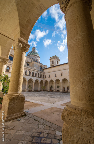 LECCE, Puglia ,Italy - Inside courtyard of university of Salento - UniSalento (Universita del Salento) and view to cupola of the church chiesa Maria ss.del Carmine. Apulia region