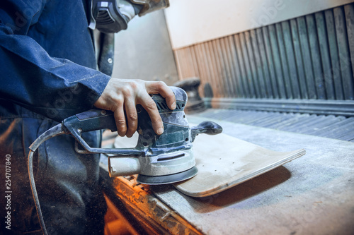 Fotografie Carpenter using circular saw for cutting wooden boards