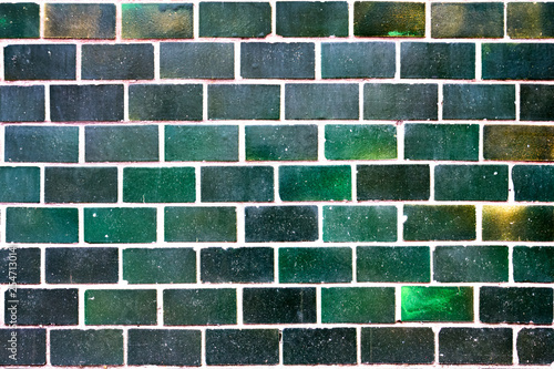 Old green tiles on the wall as background