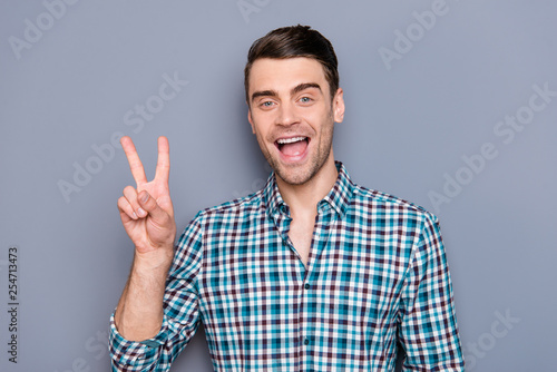 Close up photo amazing he him his man arms hands show v-sign say hi amazed excited good mood ideal perfect hairdo styling wearing casual plaid checkered outfit isolated grey background