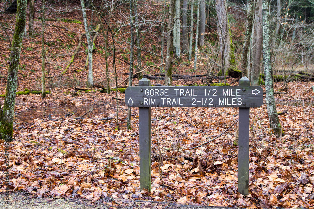 Exploring Hocking Hills. Trail marker for hikers in Hocking Hills at the Rock House scenic area. Exploring Hocking Hills. Trail marker for hikers in Hocking Hills at the Rock House scenic area.