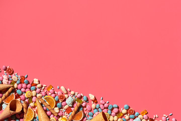 Various sweets, candys are palced on the photo on the coral background