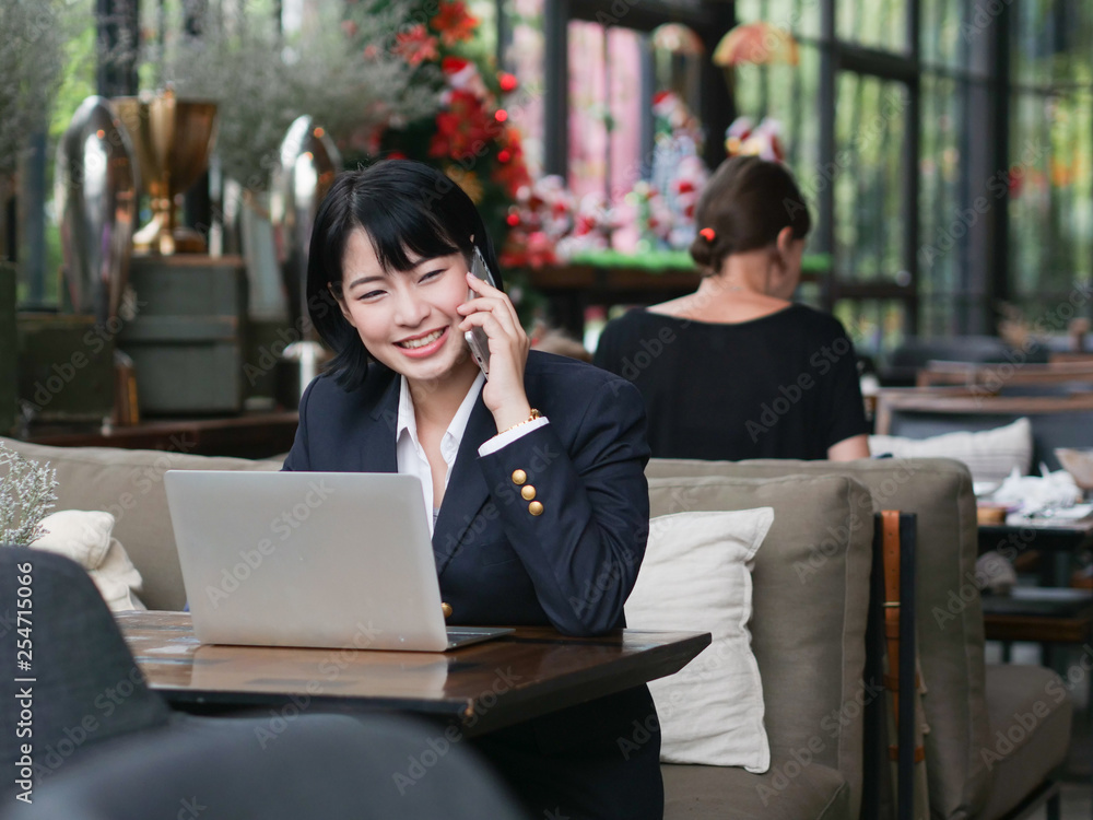 Asian business girl working and drinking coffee in cafe Asian business girl working and drinking coffee in cafe