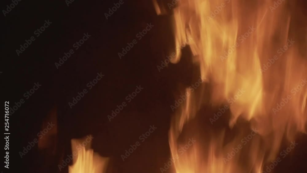 Background of a flaming campfire in darkness with sparks and ash Background of a flaming campfire in darkness with sparks and ash