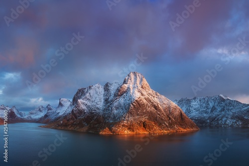 The Lofoten Islands are an archipelago in the county of Nordland, Norway. It is known for its distinctive scenery with dramatic mountains and peaks, open sea and sheltered bays, beaches, drone view © Michal