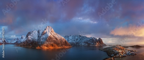 Fototapeta Naklejka Na Ścianę i Meble -  The Lofoten Islands are an archipelago in the county of Nordland, Norway. It is known for its distinctive scenery with dramatic mountains and peaks, open sea and sheltered bays, beaches, drone view 