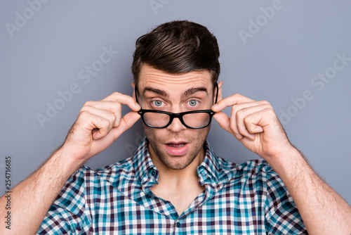 Close up photo attractive amazing macho he him his man attentively looking on camera do not believe eyes not good bad novelty wear specs casual plaid checkered shirt outfit isolated grey background
