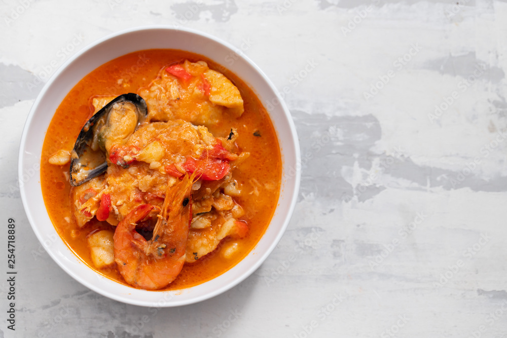 typical portuguese fish and seafood stew caldeirada in dish on ceramic background typical portuguese fish and seafood stew caldeirada in dish on ceramic background