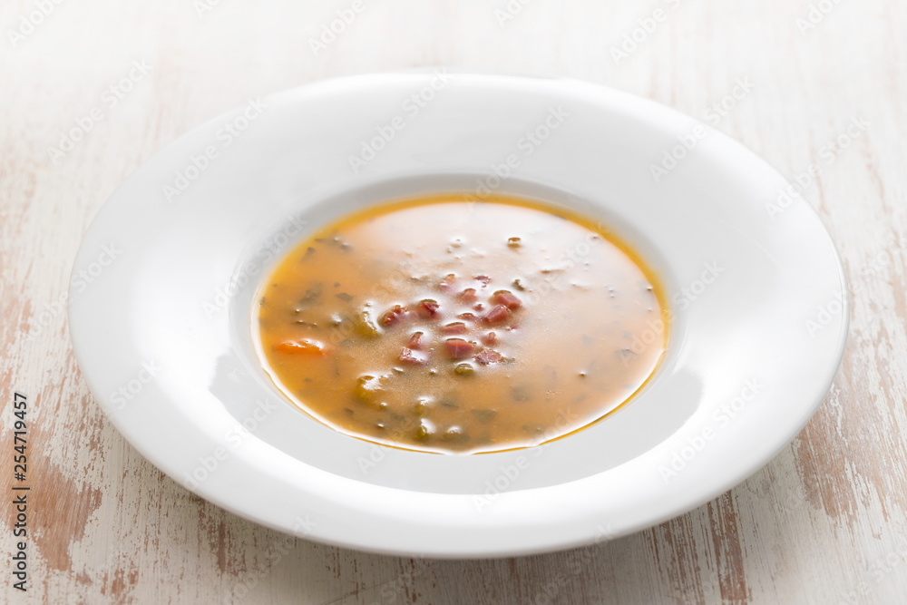 soup with smoked meat in white plate on wooden dish soup with smoked meat in white plate on wooden dish