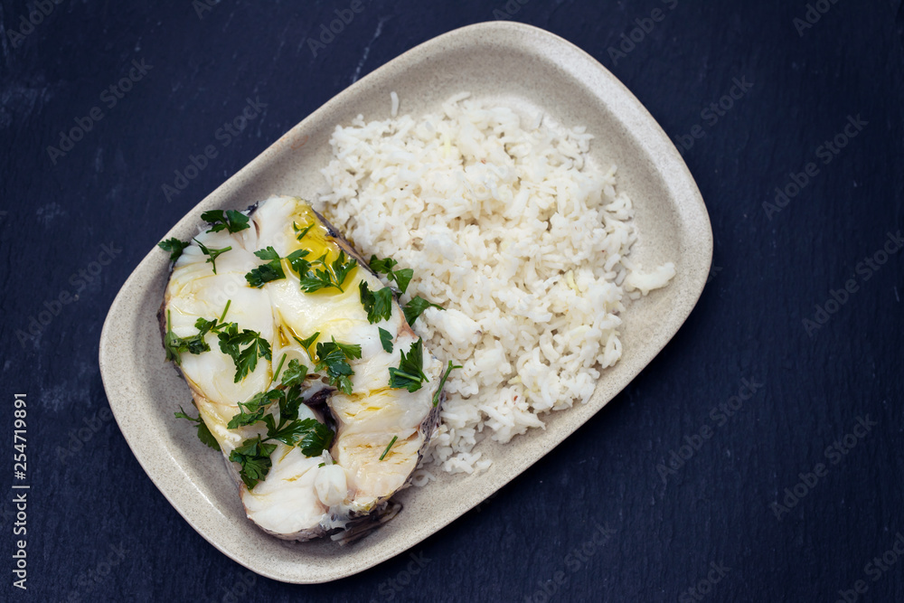 boiled perch with parsley and boiled rice on dish on ceramic background boiled perch with parsley and boiled rice on dish on ceramic background