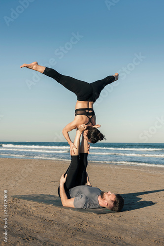 Young couple practicing acroyoga exercise