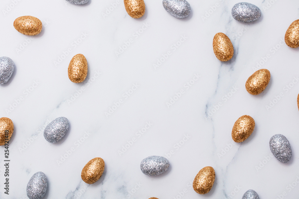 Gold and silver glitter easter eggs on a marble background Gold and silver glitter easter eggs on a marble background
