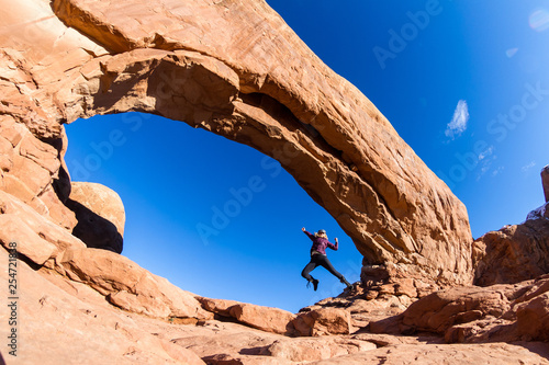 Woman Jumping in Arches