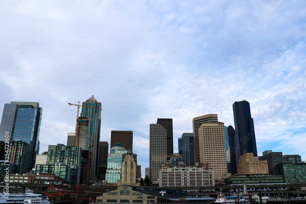 Seattle, USA, August 31, 2018: Seattle waterfront Pier 55 and 54. Downtown view from ferry.