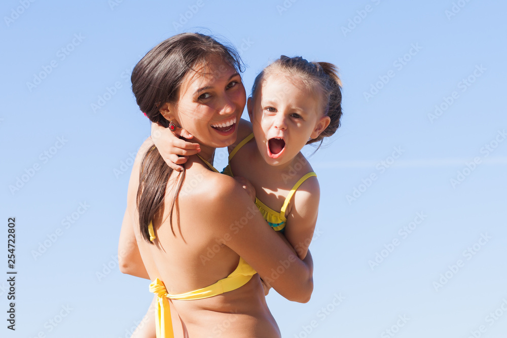 Mom and daughter playing on the beach Mom and daughter playing on the beach