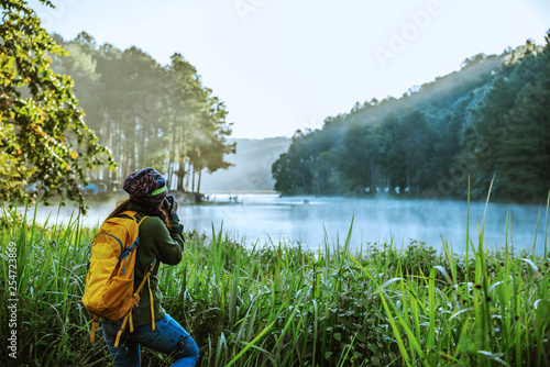 asian women traveller stand take pictures of nature landscape the beautiful in Thailand.