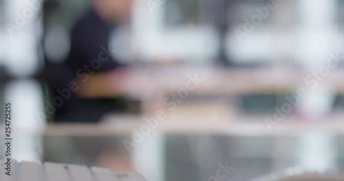 Blurry shot of person working in an office room, perfect to use as template