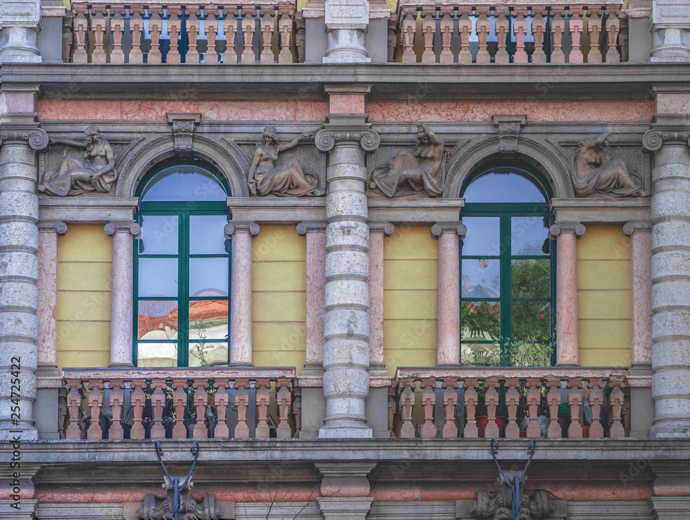 milano - Italy, windows on the facade of a historic house with bas-reliefs
