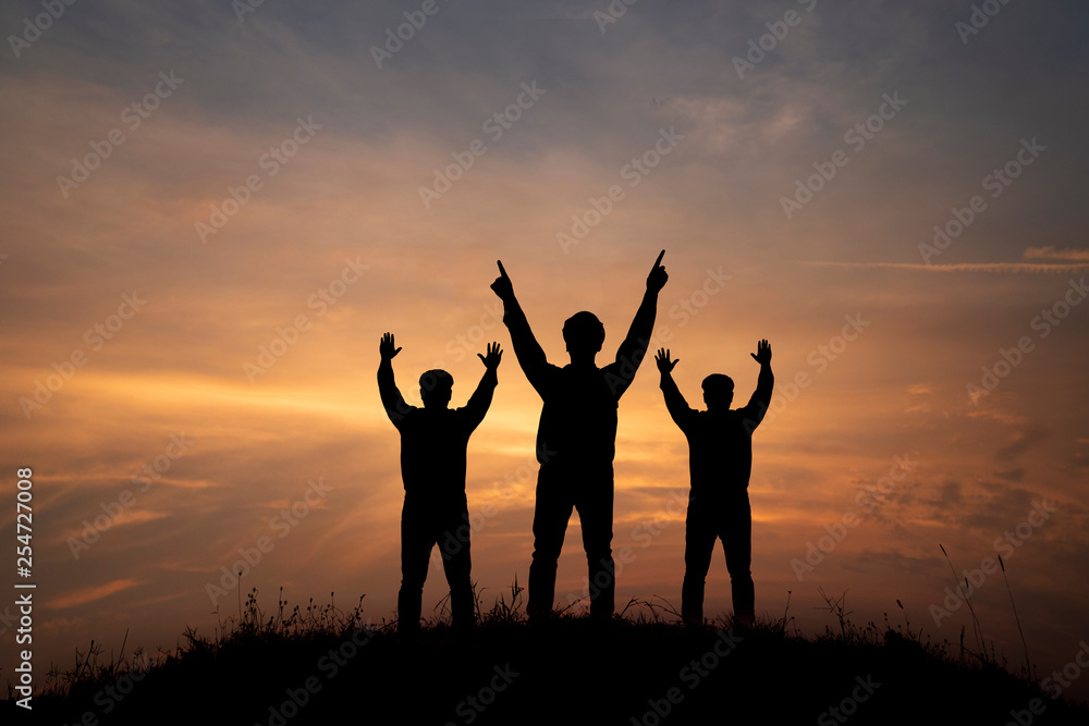silhouette three men on peak mountain silhouette three men on peak mountain