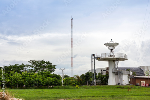 High technology satellite dish or radio telescopes station and radio antenna pole on cloudy sky day