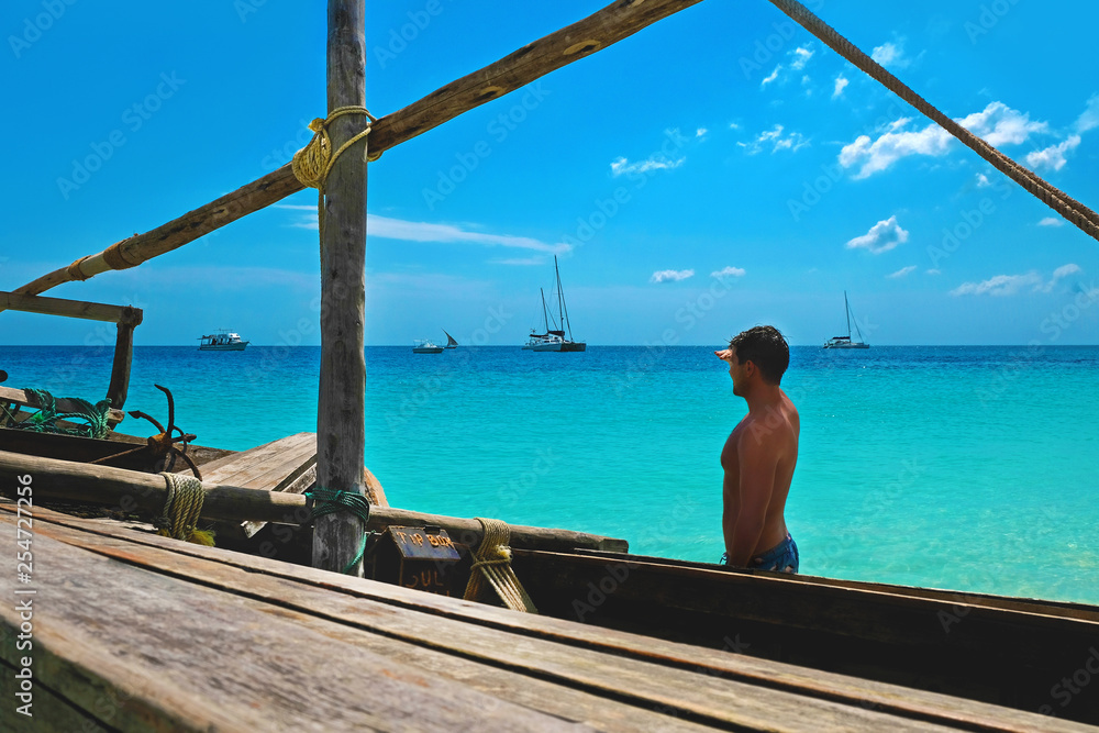 Young attractive man portrays a sailor on a wooden ship Young attractive man portrays a sailor on a wooden ship