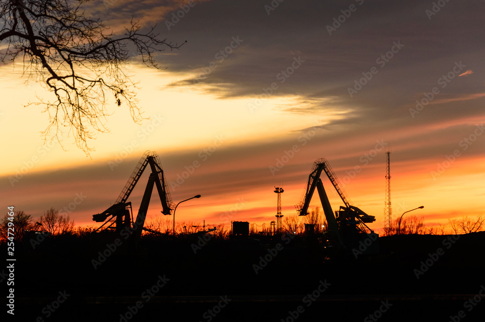 Excavators for loading coal on the background of the setting sun. Excavators for loading coal on the background of the setting sun.