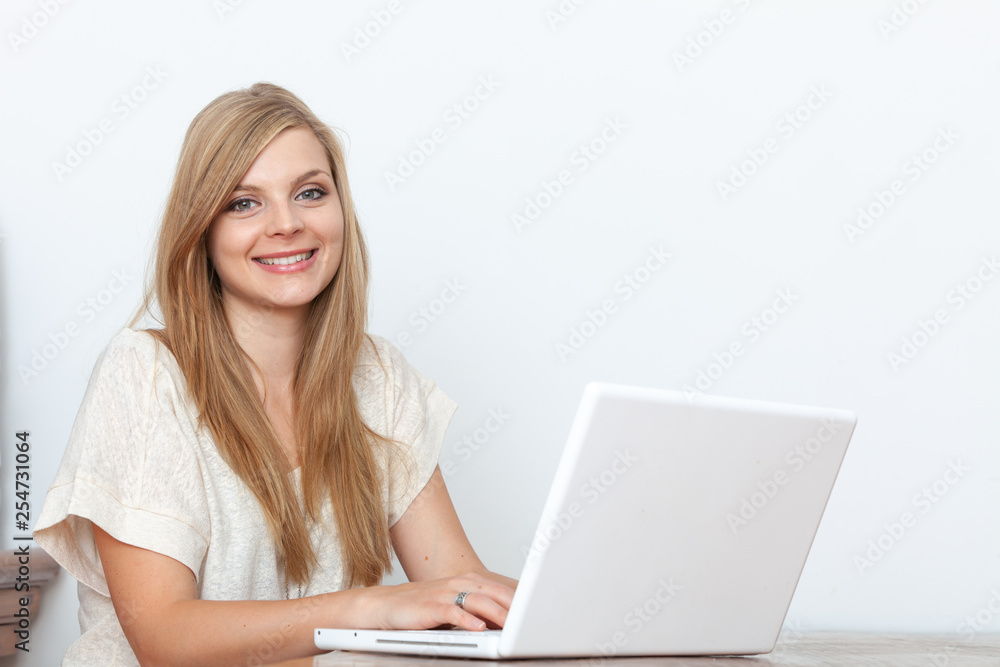 Young woman using a notebook computer indoors Young woman using a notebook computer indoors