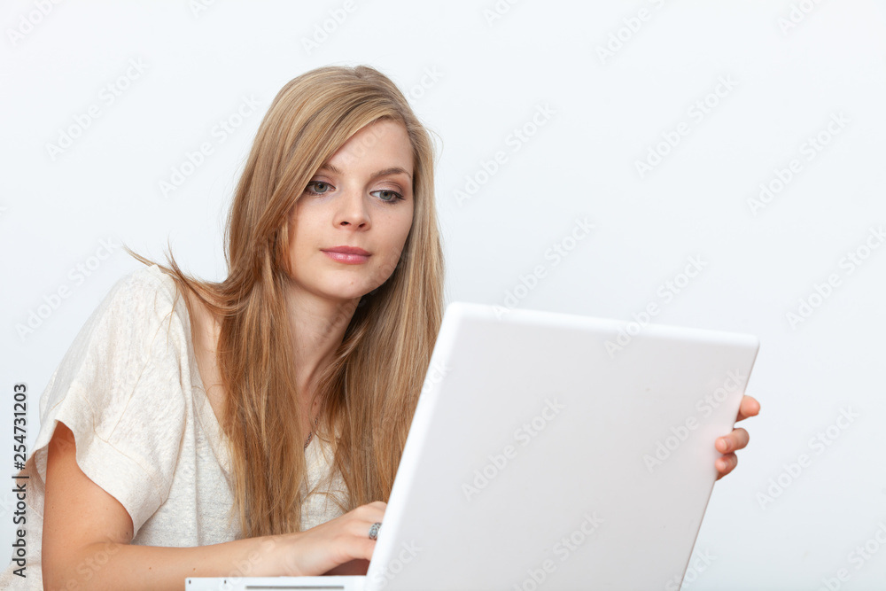 Young woman using a notebook computer indoors Young woman using a notebook computer indoors