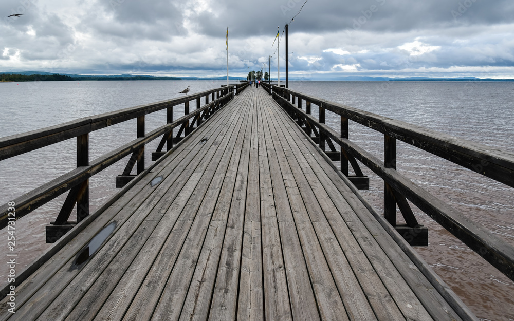 Long wooden pedestrian pier jutting out in Siljan Lake - Rattvik, Sweden.