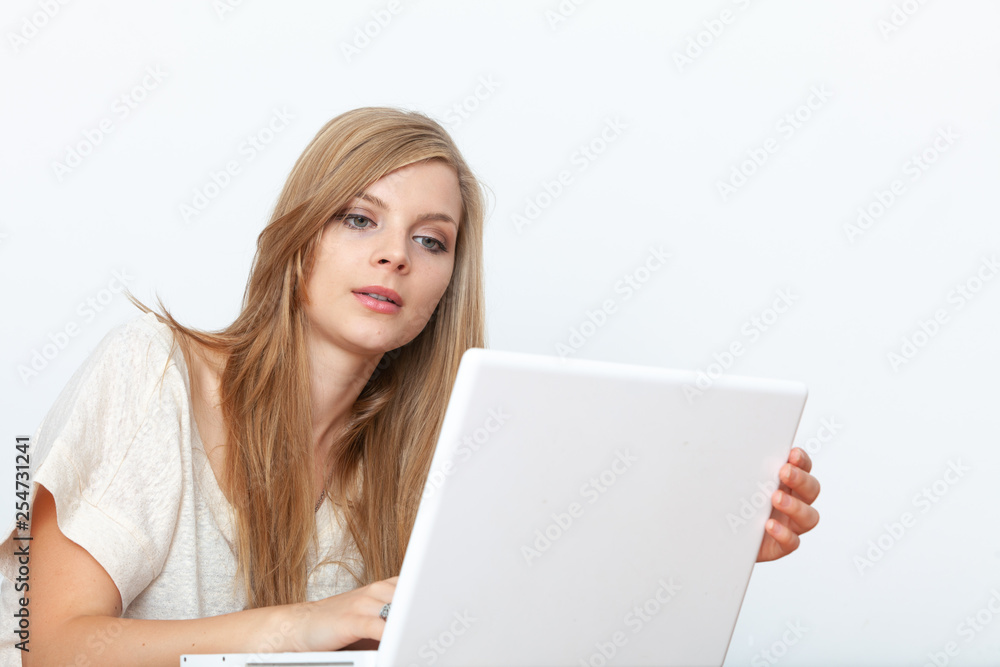 Young woman using a notebook computer indoors Young woman using a notebook computer indoors