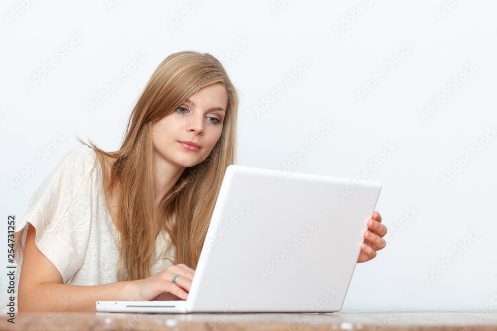 Young woman using a notebook computer indoors Young woman using a notebook computer indoors