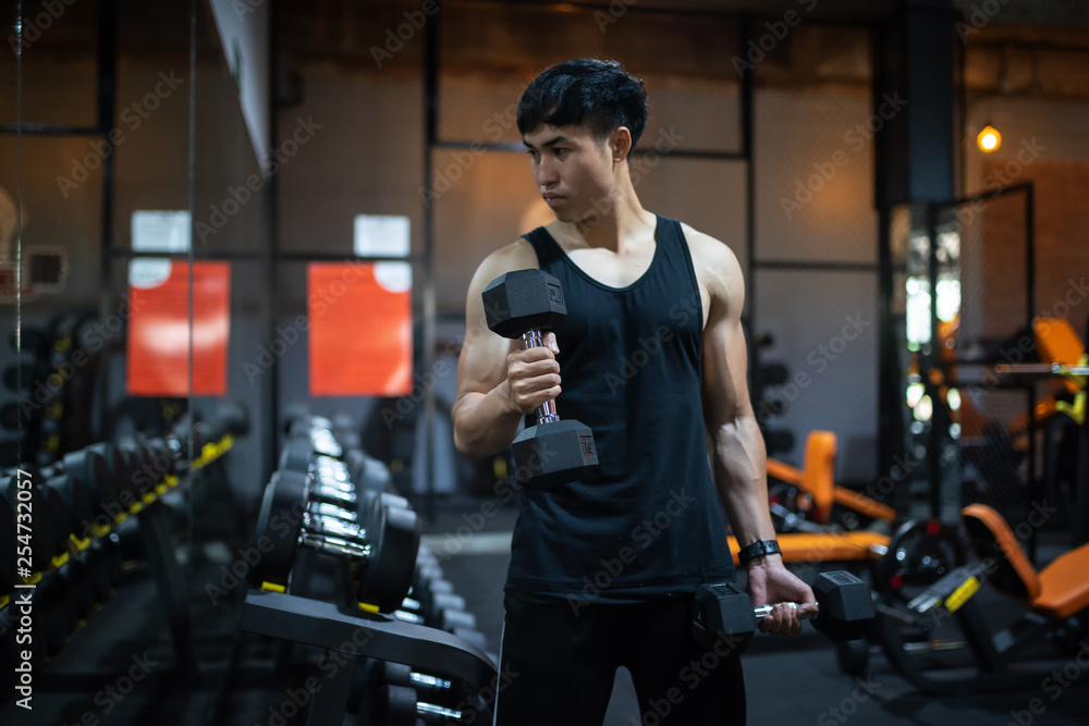 Asian sports men performing exercise on lifting barbells working out iin fitness center. Asian sports men performing exercise on lifting barbells working out iin fitness center.