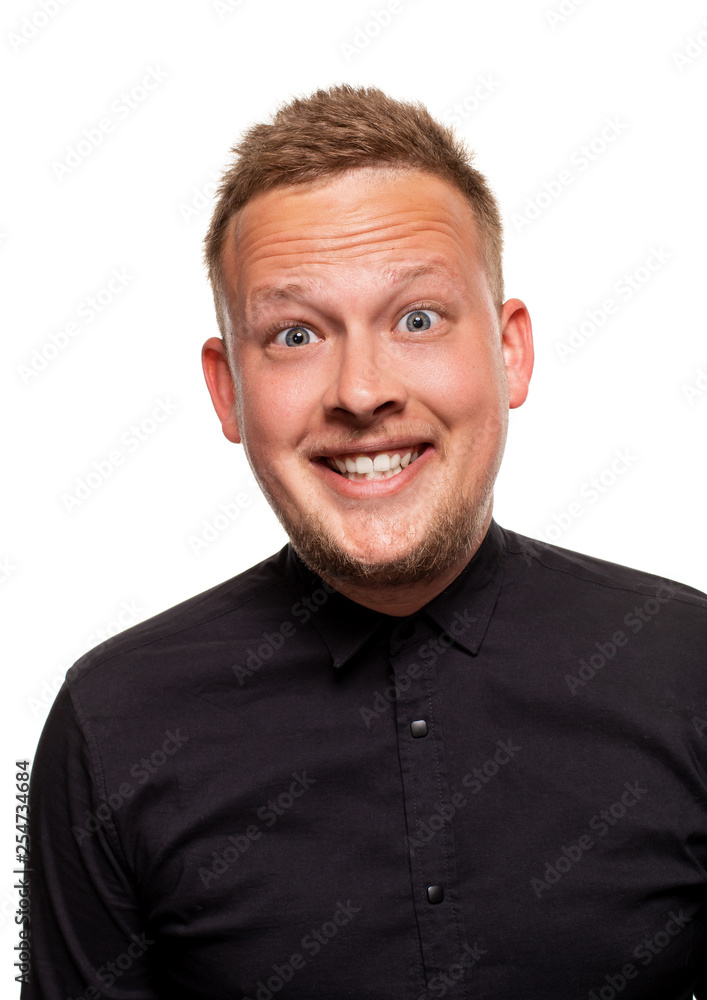 Obraz premium Close up portrait of a confident, blond, handsome young man wearing black shirt, isolated on white background